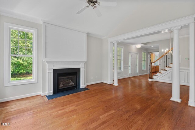 unfurnished living room with ceiling fan, stairway, a fireplace with flush hearth, light wood finished floors, and vaulted ceiling
