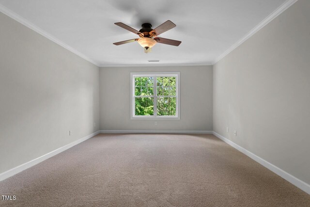 empty room with crown molding, ceiling fan, light carpet, baseboards, and visible vents