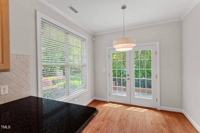 unfurnished dining area with french doors, visible vents, a healthy amount of sunlight, and light wood-type flooring