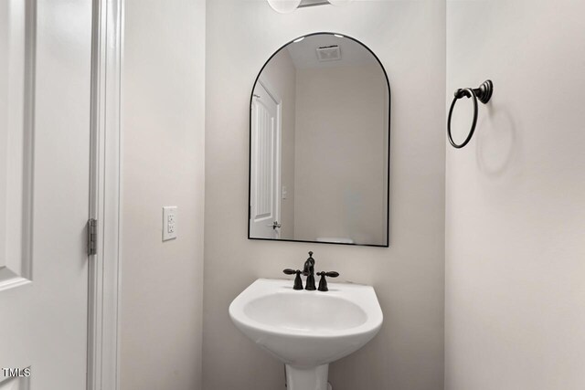 bathroom with visible vents and a sink