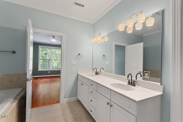 full bathroom with a sink, double vanity, tile patterned floors, visible vents, and ornamental molding