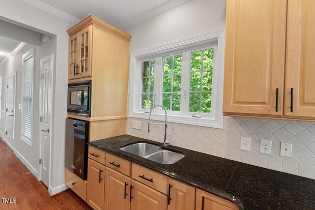 kitchen featuring backsplash, black microwave, wall oven, a sink, and ornamental molding