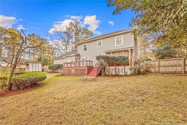 rear view of property featuring a lawn, a wooden deck, and a storage unit