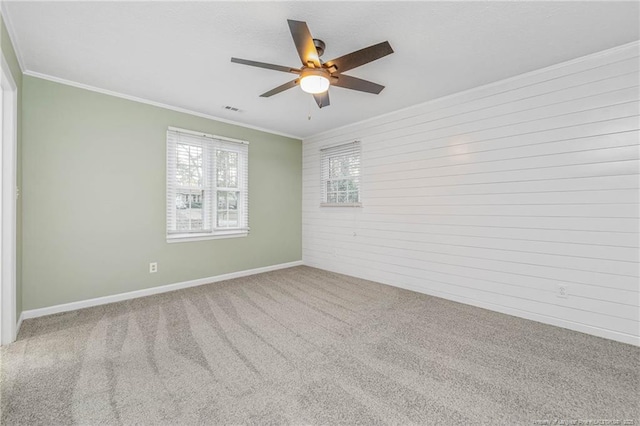 carpeted empty room featuring ceiling fan and ornamental molding