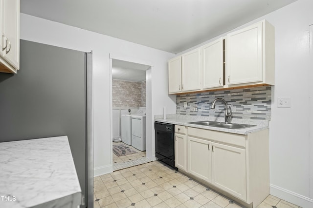 kitchen with black dishwasher, white cabinetry, decorative backsplash, sink, and separate washer and dryer