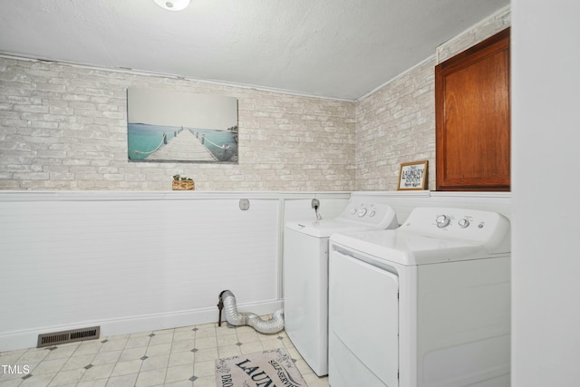 laundry room with washer and dryer and cabinets