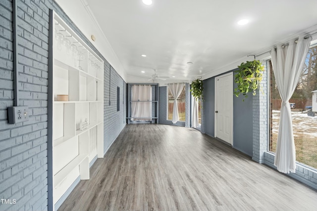 interior space with plenty of natural light, hardwood / wood-style flooring, and ornamental molding