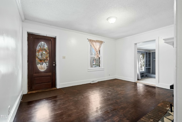 foyer featuring crown molding, hardwood / wood-style flooring, and a textured ceiling