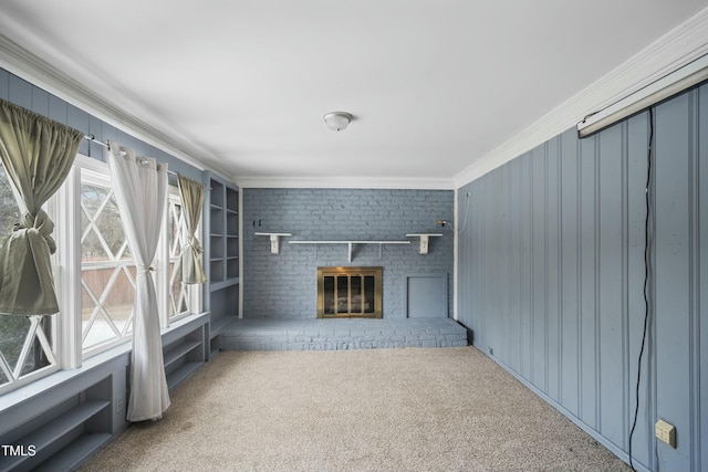 unfurnished living room with a brick fireplace, carpet, and ornamental molding