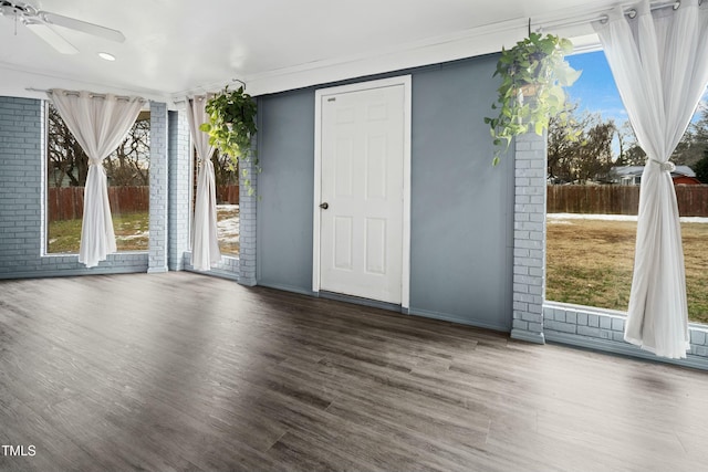 spare room with crown molding, ceiling fan, and dark hardwood / wood-style flooring