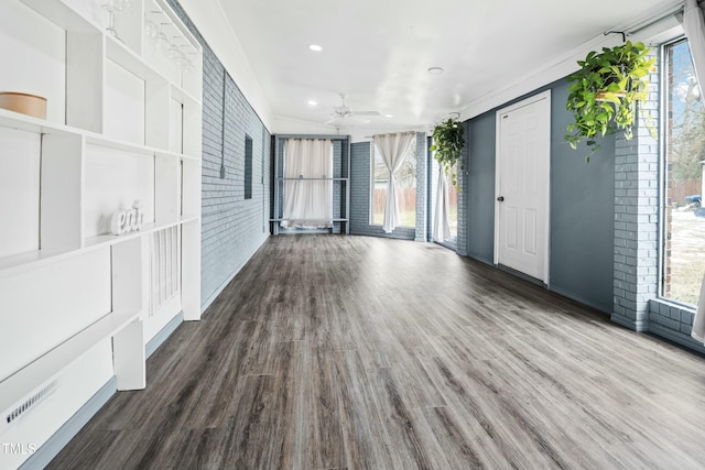 spare room featuring plenty of natural light, hardwood / wood-style floors, and ornamental molding