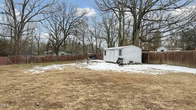 yard covered in snow with an outbuilding