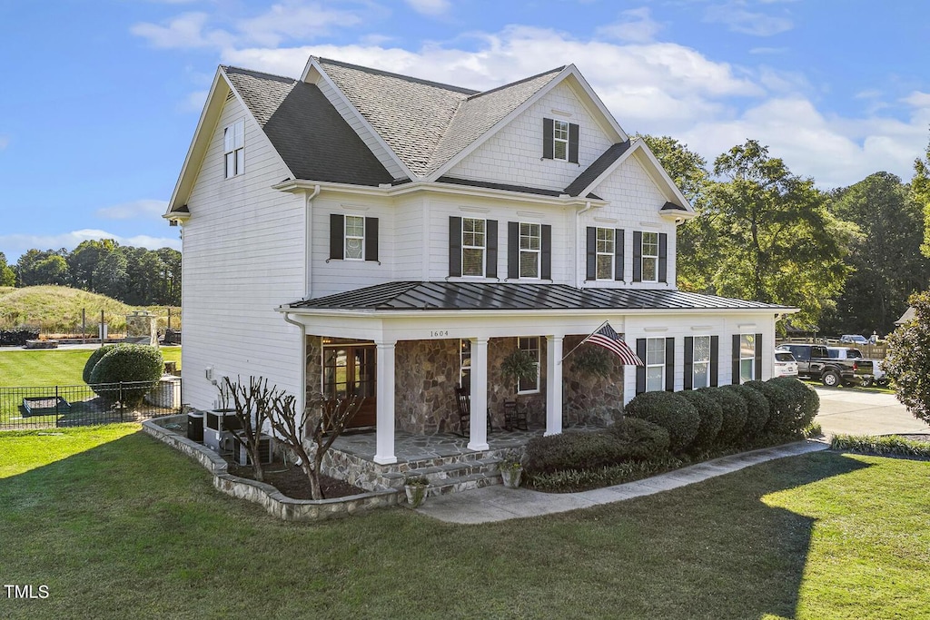 view of front of home featuring a porch and a front lawn