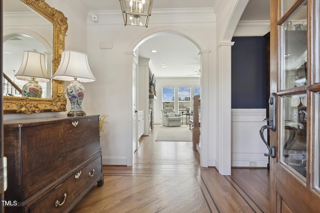 hallway featuring ornamental molding and hardwood / wood-style floors