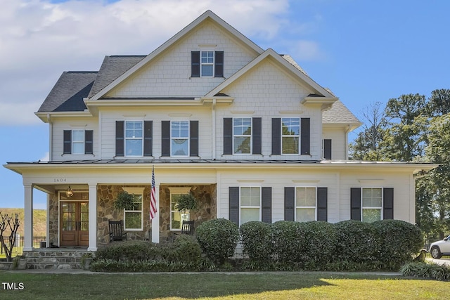 view of front of property with a porch and a front yard