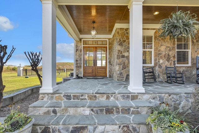 entrance to property featuring french doors and a porch