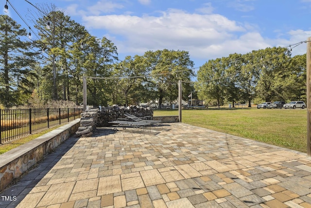 view of property's community featuring a patio area and a lawn