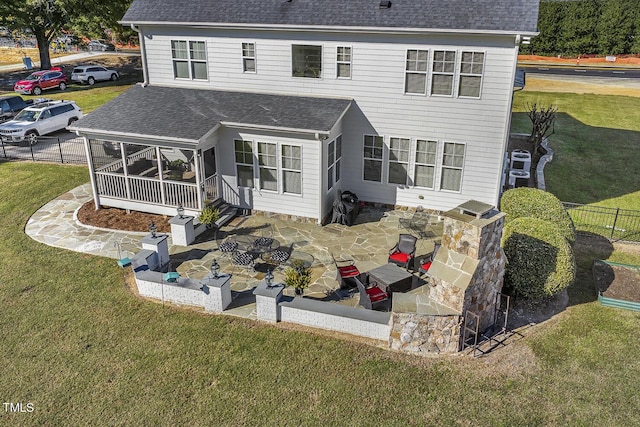 rear view of property with a yard and a patio area