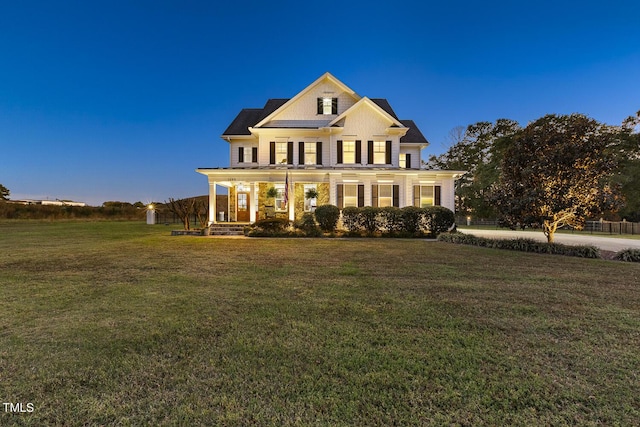 view of front of home featuring a porch and a yard