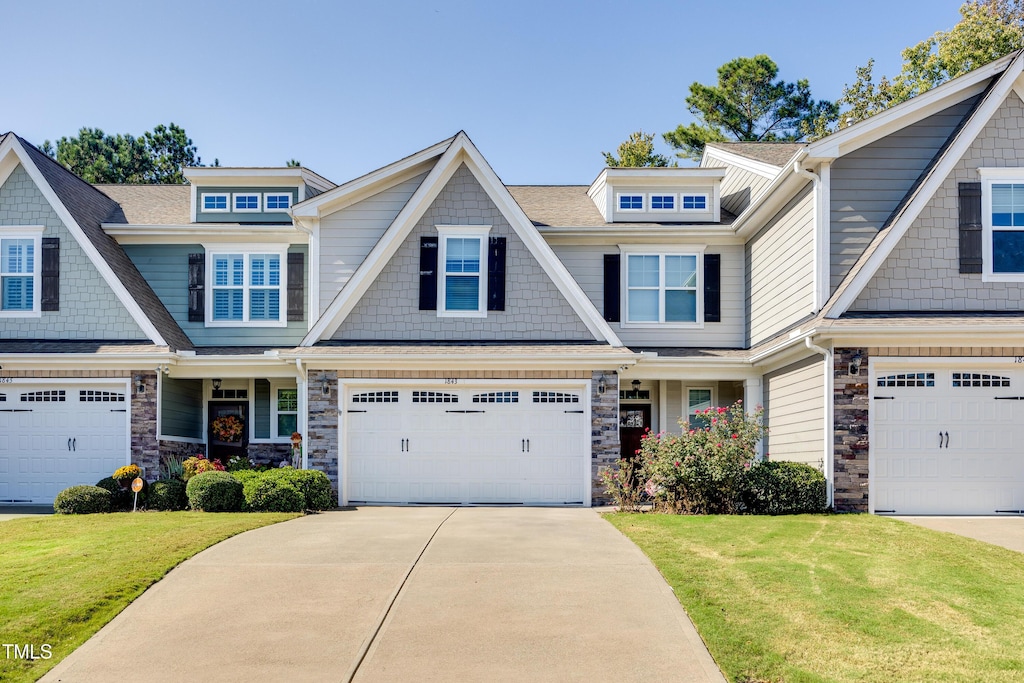 craftsman-style home featuring a garage and a front yard