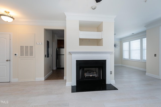 unfurnished living room with crown molding and light wood-type flooring