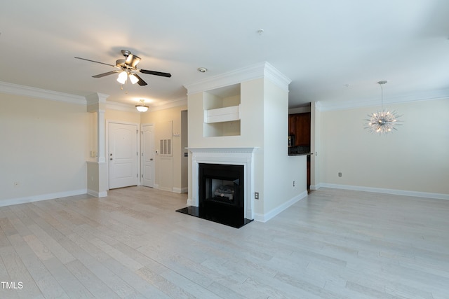 unfurnished living room featuring ceiling fan with notable chandelier, ornamental molding, and light hardwood / wood-style floors