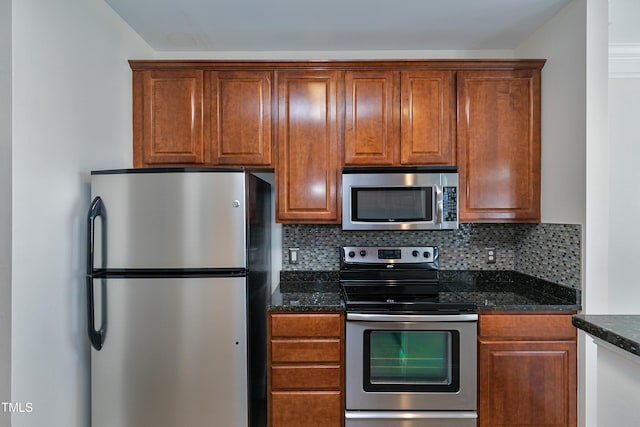 kitchen featuring tasteful backsplash, appliances with stainless steel finishes, and dark stone counters