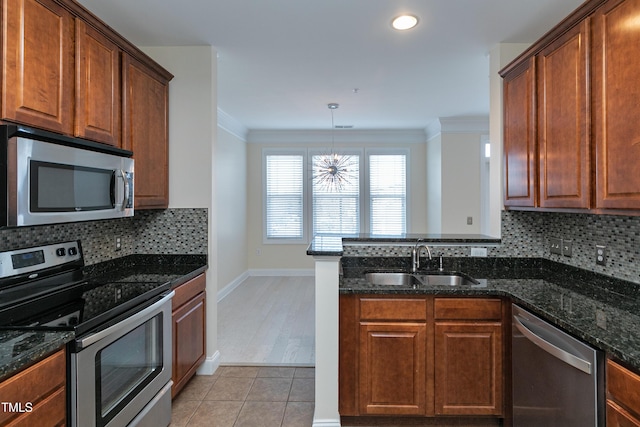 kitchen featuring backsplash, appliances with stainless steel finishes, sink, and light tile patterned floors