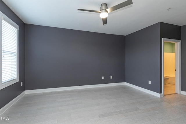 empty room featuring ceiling fan and light hardwood / wood-style floors