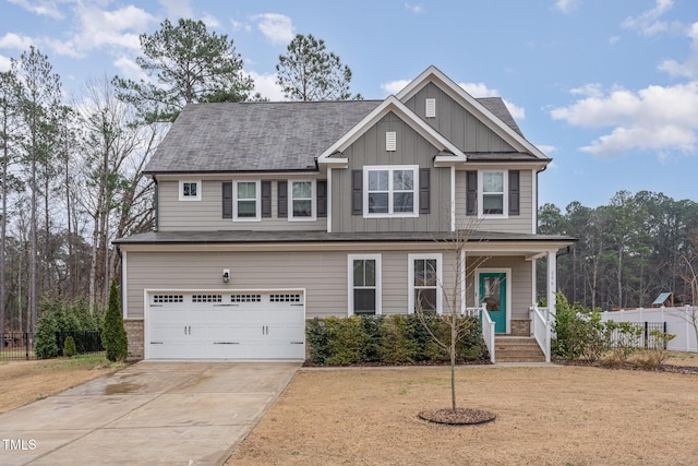 view of front of home featuring driveway, board and batten siding, an attached garage, and fence