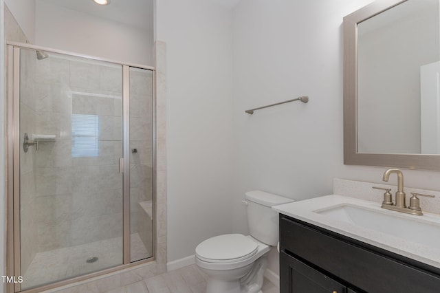 bathroom with a stall shower, vanity, and toilet