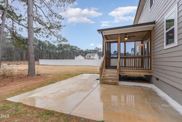 view of patio / terrace featuring a sunroom and fence