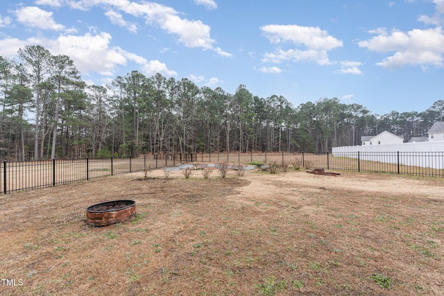 view of yard with an outdoor fire pit and fence