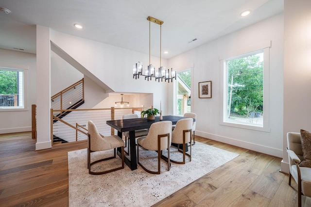 dining room with a notable chandelier and wood-type flooring