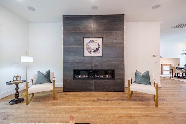 living area with a fireplace and hardwood / wood-style floors