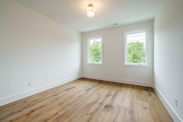 spare room with light hardwood / wood-style flooring