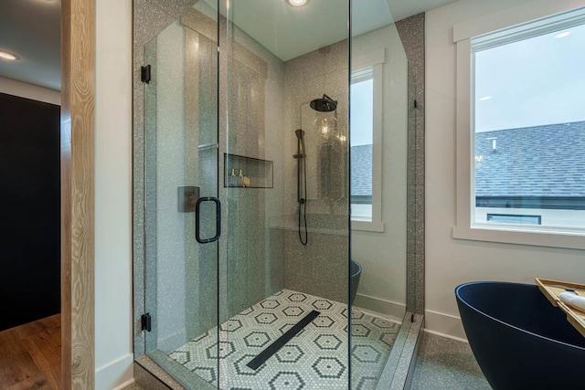 bathroom with a shower with door