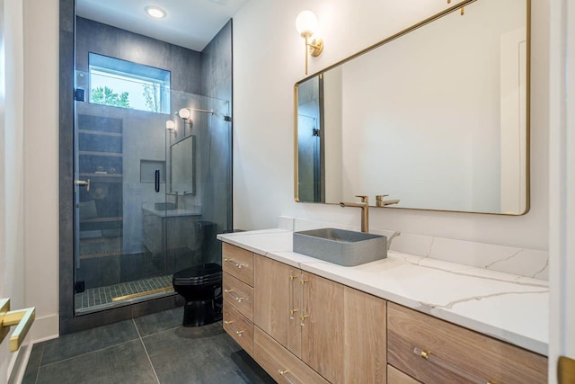 bathroom featuring tile patterned floors, vanity, toilet, and a shower with door