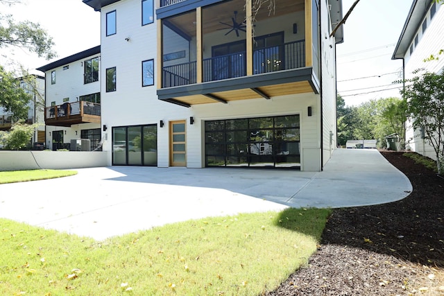 back of house featuring ceiling fan and a balcony