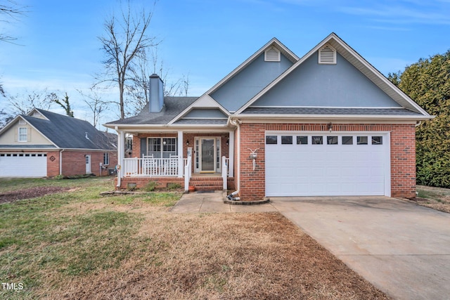 view of front of property with a garage, a front lawn, and covered porch