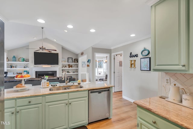 kitchen featuring stainless steel dishwasher, sink, green cabinets, and decorative backsplash