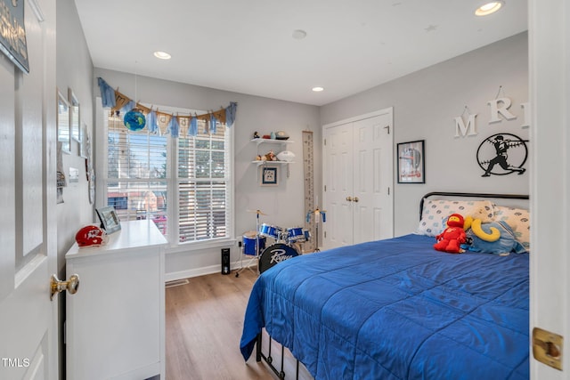 bedroom featuring a closet and light wood-type flooring