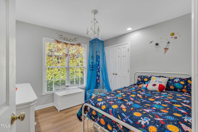 bedroom featuring light hardwood / wood-style floors and a closet