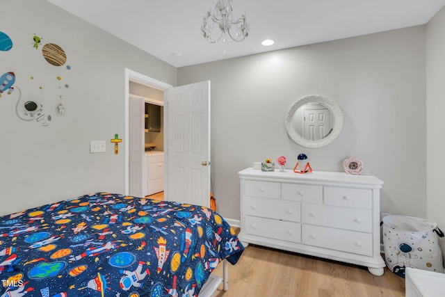 bedroom featuring washer / dryer and light hardwood / wood-style flooring