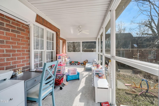 sunroom / solarium featuring ceiling fan