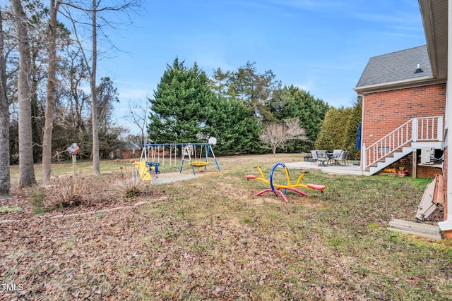 view of yard with a playground and a patio