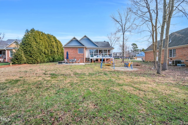 view of yard with a sunroom and a patio