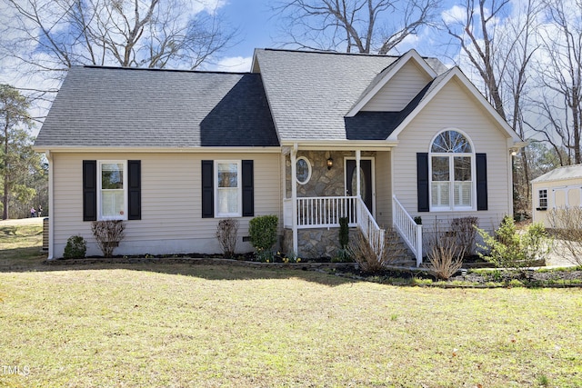 view of front of home with stone siding, a porch, a shingled roof, and a front yard