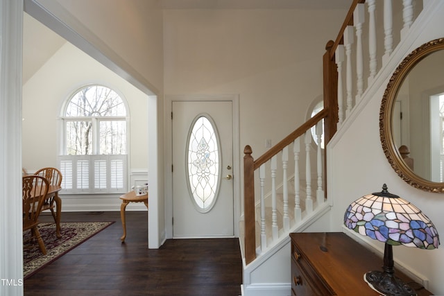 foyer featuring stairway, baseboards, and dark wood-style floors