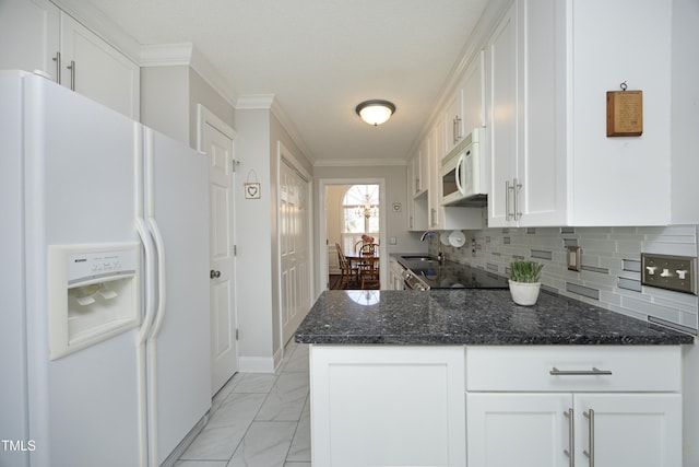 kitchen featuring marble finish floor, ornamental molding, backsplash, white cabinetry, and white appliances